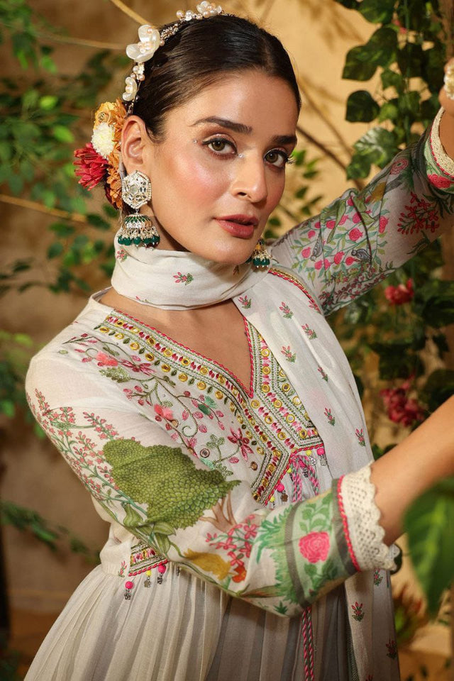 Featuring beautiful MUSLIN ALIA CUT Suit Set which is beautifully decorated with intricate hand embroidery, Zari weaving and prints. It is paired with matching pants and lace dupatta | White